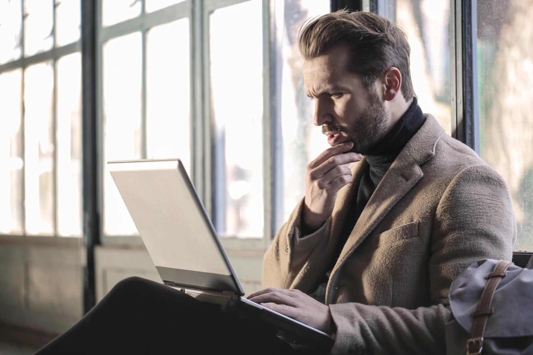 A founder thinking through a problem at his laptop