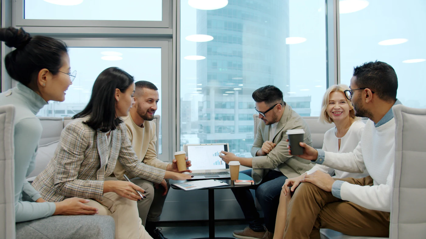 A founder and team working through a plan around a table